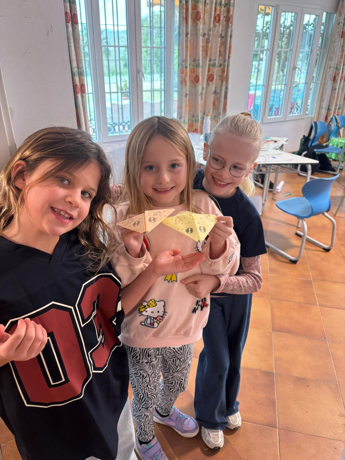 Young children doing creative activities at Mini AIM